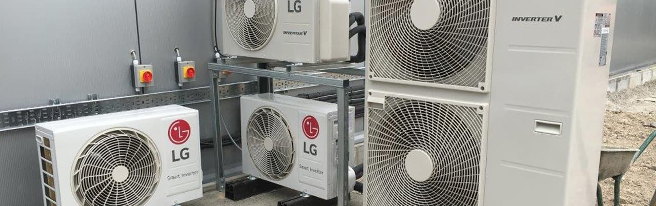 Outdoor LG inverter condenser stack installed by Cool Solutions — multi-unit air-conditioning rack.