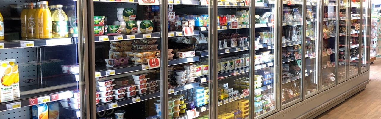 Supermarket dairy fridge bank installed by Cool Solutions — refrigerated multi-deck retail display.
